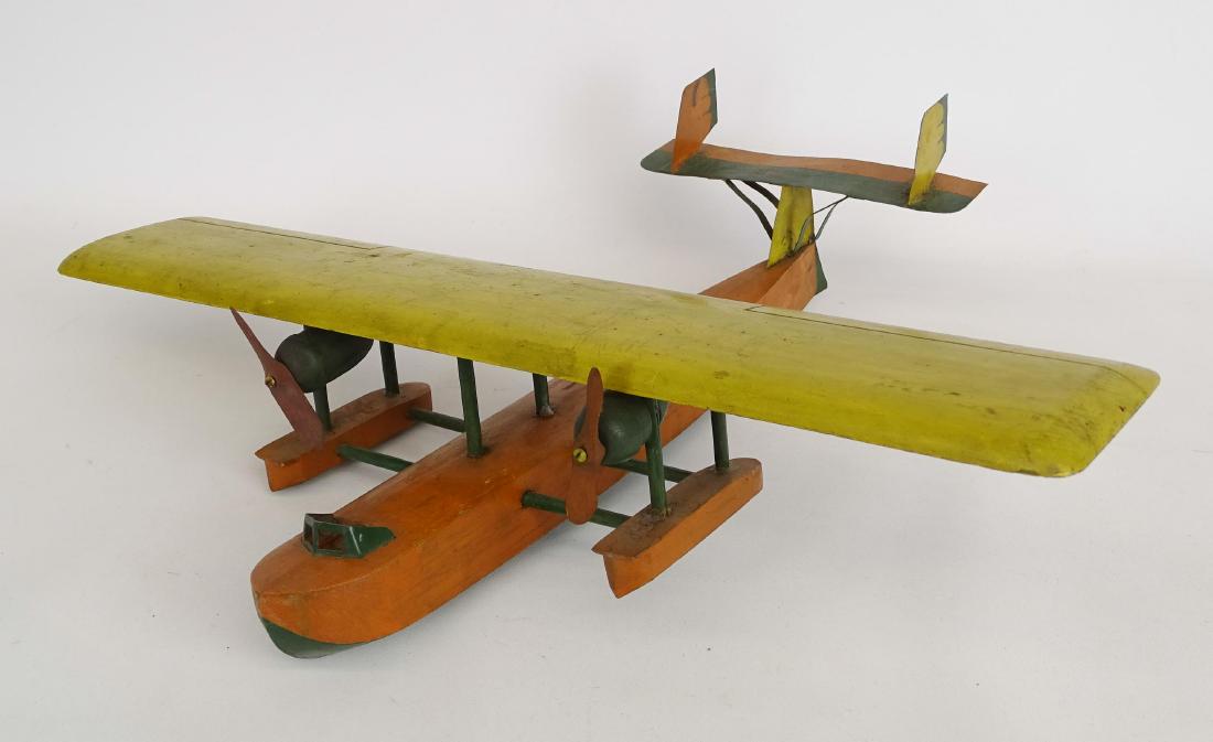 Folk Art Wooden Airplane: Folk art wood and tin, polychrome painted hydroplane. Found in The Finger Lakes region of N.Y.S.. 20" wing span, 17" L..