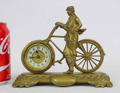 Early Brass Figural Bicycle Clock: Early brass figural bicycle clock. Man posed with safety bicycle. 7 1/2" x 3" x 6 1/2" Ht..