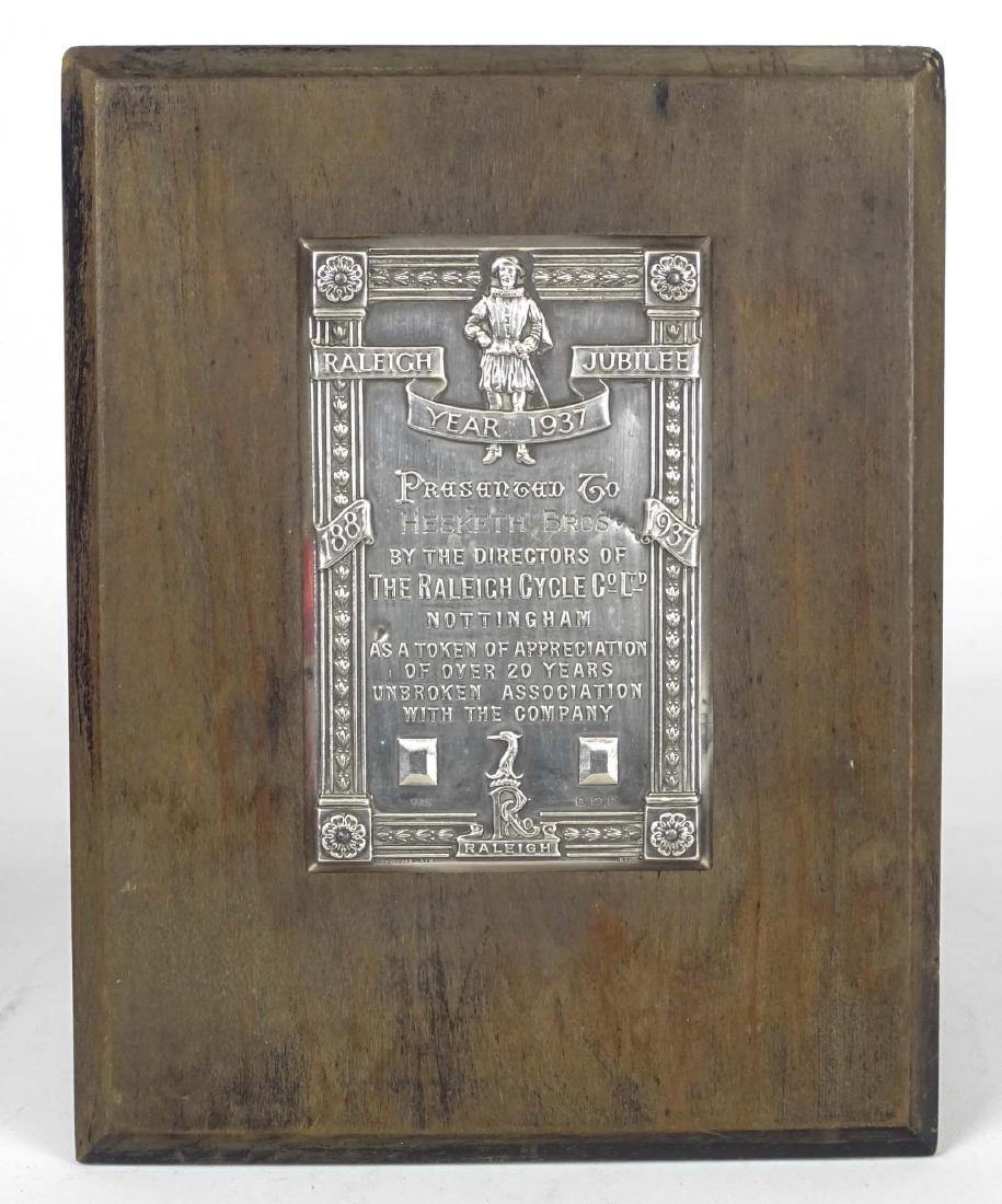 Raleigh Plaque: Raleigh appreciation plaque. Wood and silverplate. Awarded during Raleighs Jubilee year, 1937 to Hesketh Bros. For 20 Years of Association. 9 1/4" x 7 1/4". Good condition.