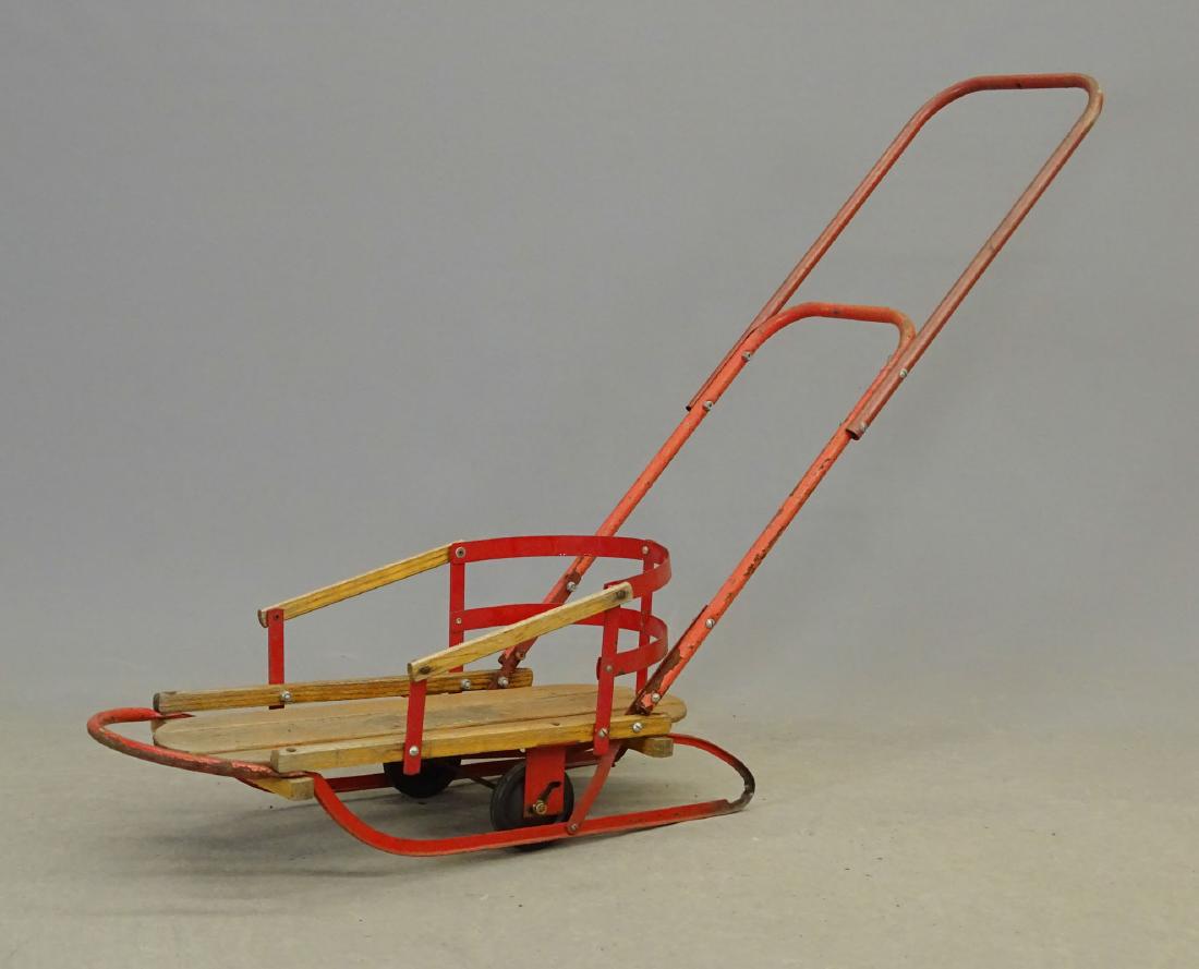 1950's Flexible Flyer Baby Sled: 1950's Flexible flyer baby sled with wheels and handle. 58" L.. Fair condition.