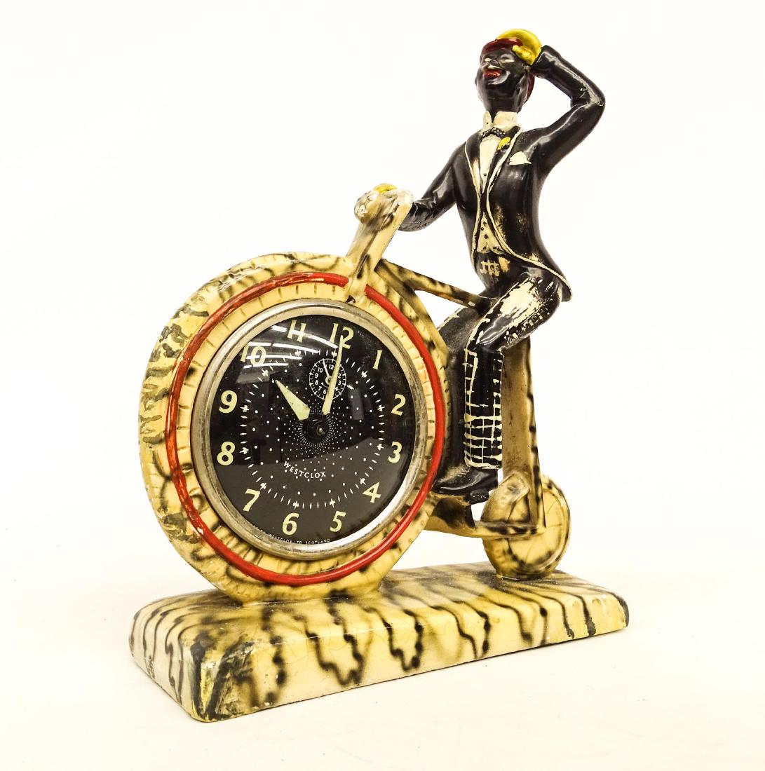 Bicycle Clock: Vintage plaster or composition bicycle clock. Figure on high wheel. Imperfections. 9" W., 12" Ht.. Ex: Woodworth Collection.