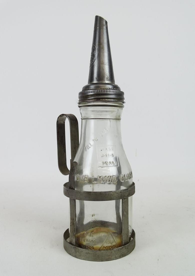 Oil Bottle: Vintage oil bottle in cradle. 14" Ht.. Good condition.