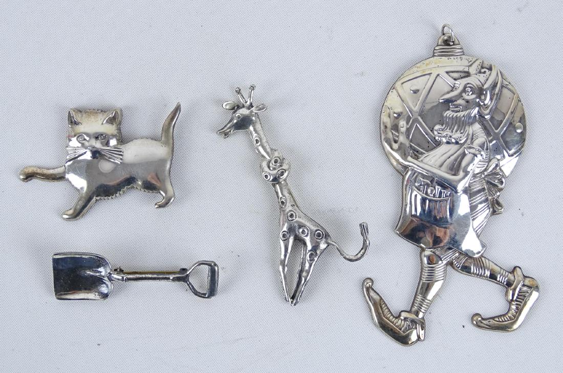 Sterling Silver Pins: Lot (4) sterling silver pins including elf with Christmas bulb, cat, shovel Giraffe.