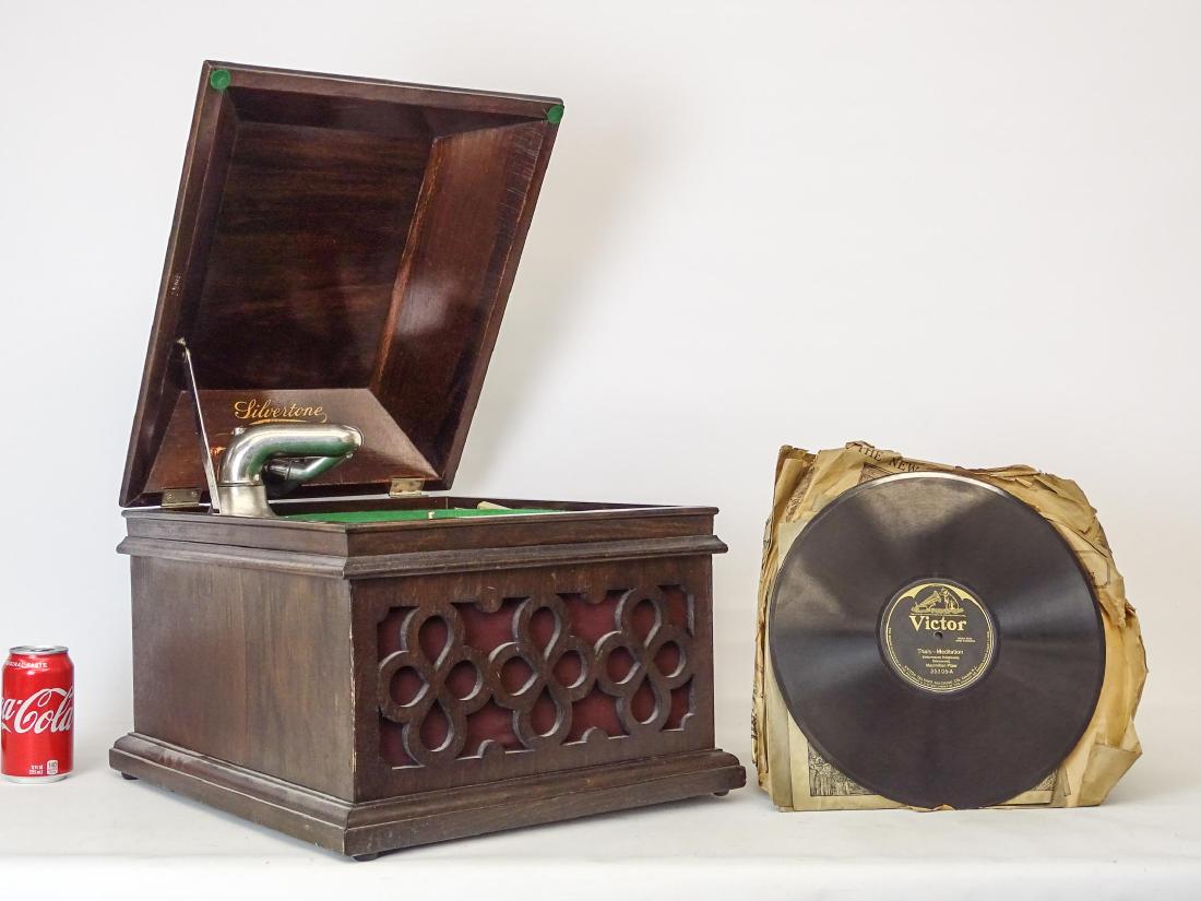 Victrola: C. 1940's mahogany case Silvertone Victrola. 15 1/2" x 18 1/2" x 14" Ht.. Works. Along with various records.