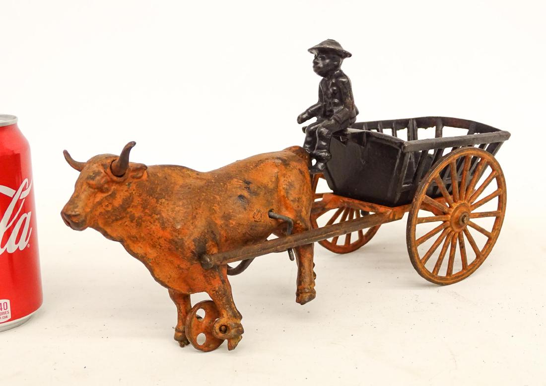 Cast Iron Cart Toy: Cast iron cart with rider and bull toy. 13" L..