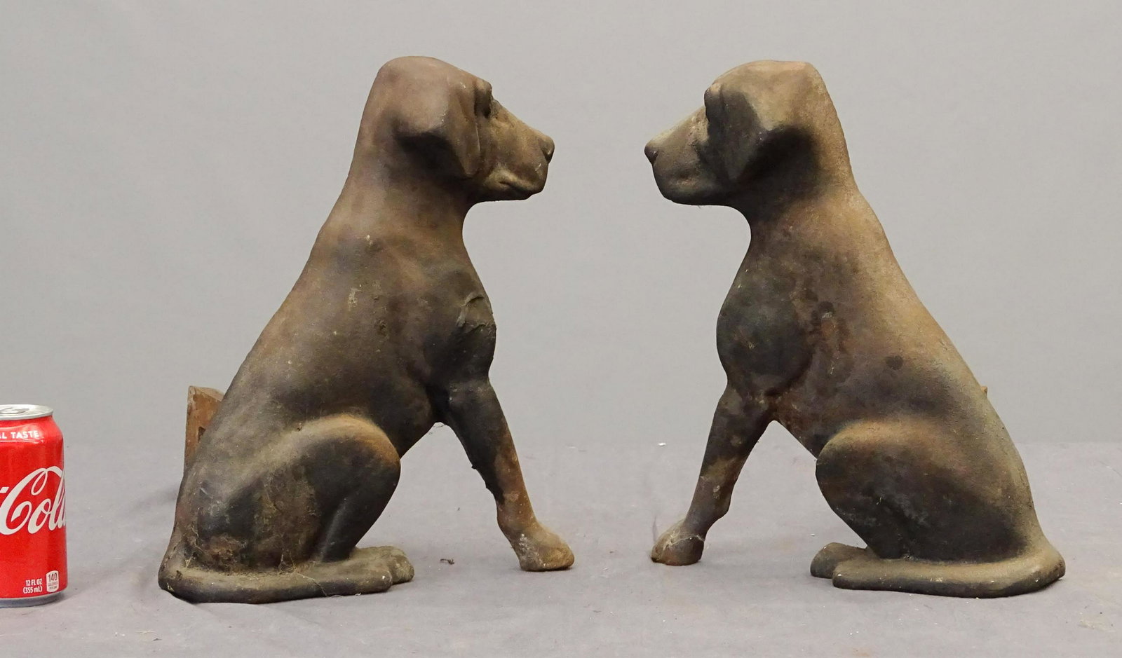 Andirons: Pair cast iron dog andirons. One marked Liberty Foys / St. Louis MO.. 15" Ht., one rear bracket needs reattaching.
