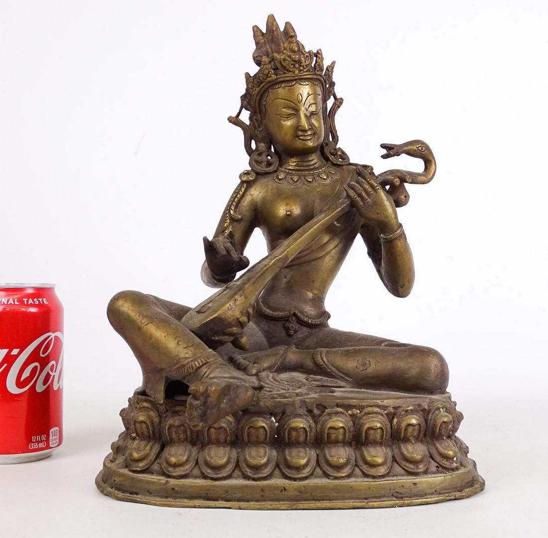 Brass Figure: Brass figure with instrument. 9" W., 13 1/2" Ht..