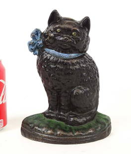 Doorstop: Sitting cat on pillow cast iron doorstop. C. 1920, National Foundry, Whitman, Mass.. Inscribed "37" backside. Ref: The Doorstop Book, Smith, p. 33. 7 3/4" Ht..