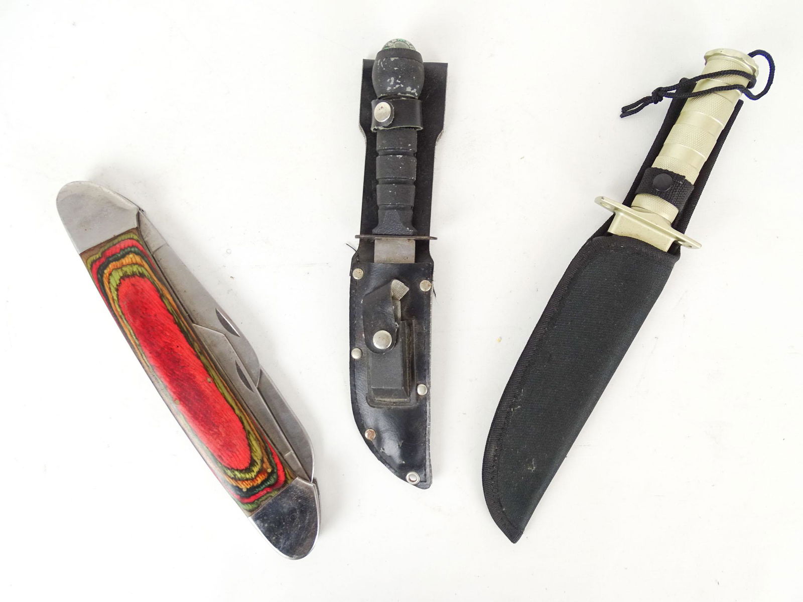 Knife Lot: Lot (3) knives including oversized pocket knife (Pakistan, 12" L.), (2) survivals (13 3/4" and 11" L.).