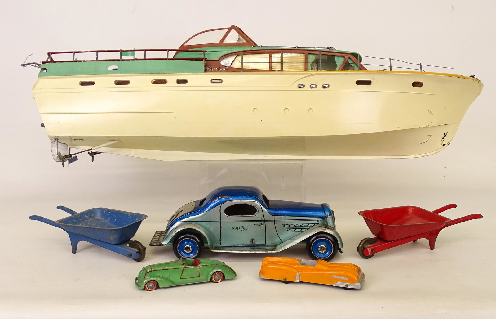 Toy Lot: Misc. toy lot including plastic boat (29" L. as found), (2) wheelbarrows (one has loose wheel), (2) cars and friction "MYSTERY CAR".