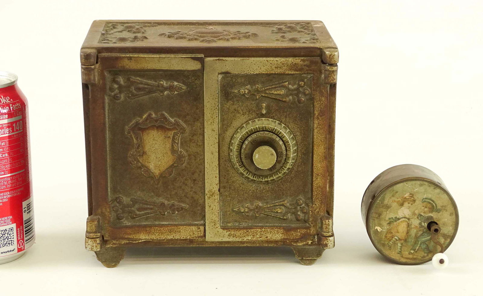 Toy Lot: Lot including early cast iron safe bank (6 1/2" x 4" x 6"), and music box toy.