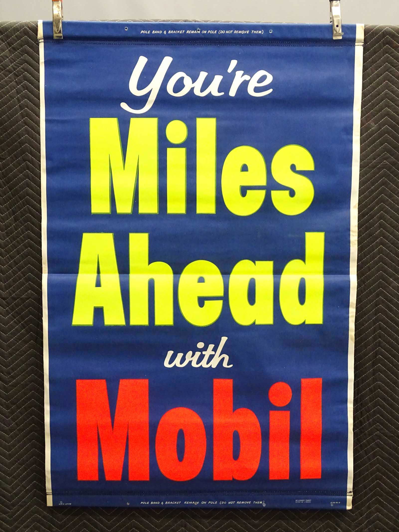 C. 1950's Automobile Roll-Up Poster: New Old Stock C. 1950's Automobile roll-up Mobil advertising poster. 36 1/2" x 57". Canvas roll-down poster.