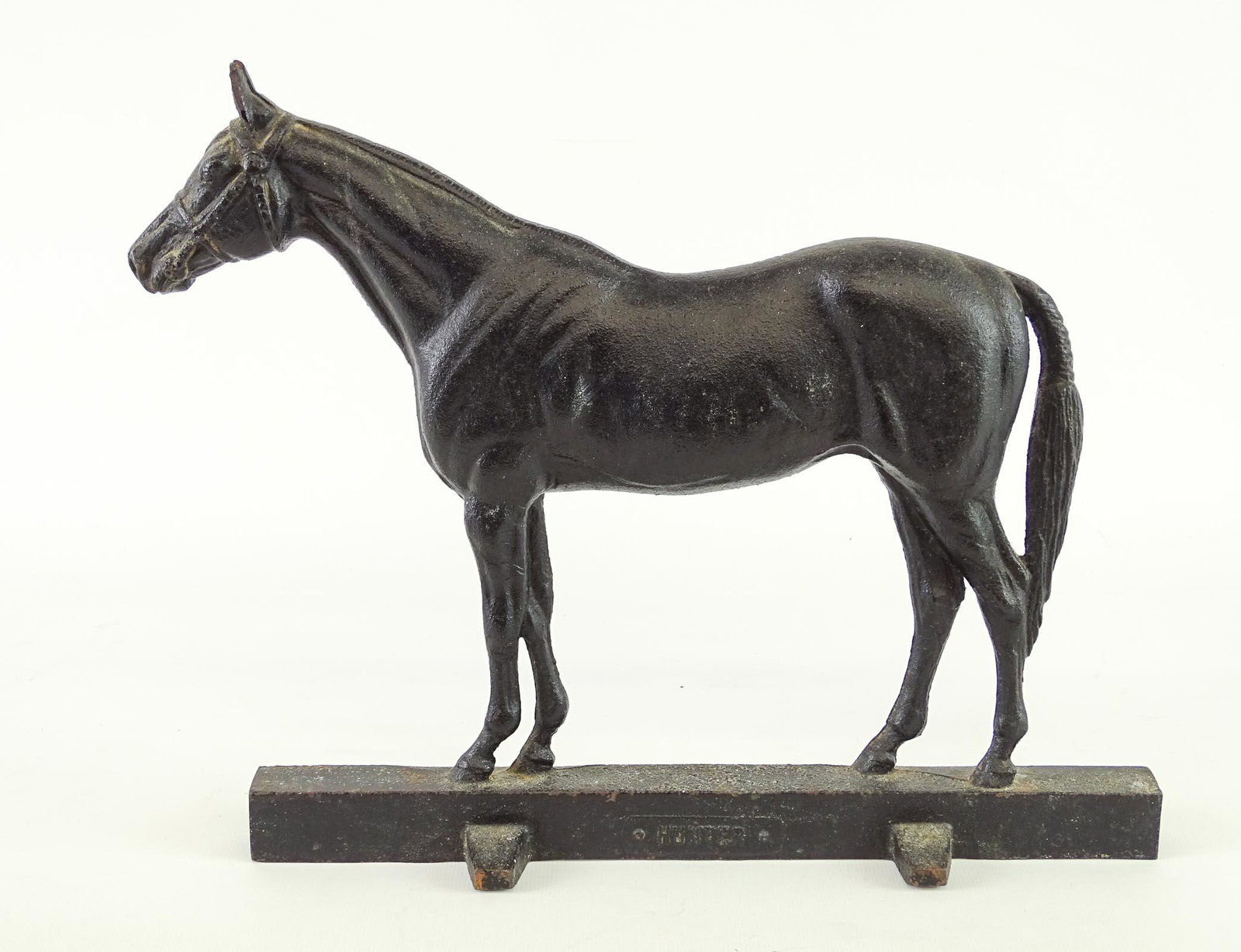 Doorstop: Cast iron horse doorstop marked "HUNTER" on front. Marked reverse "Copyright 1949....". 12" x 10 1/2".