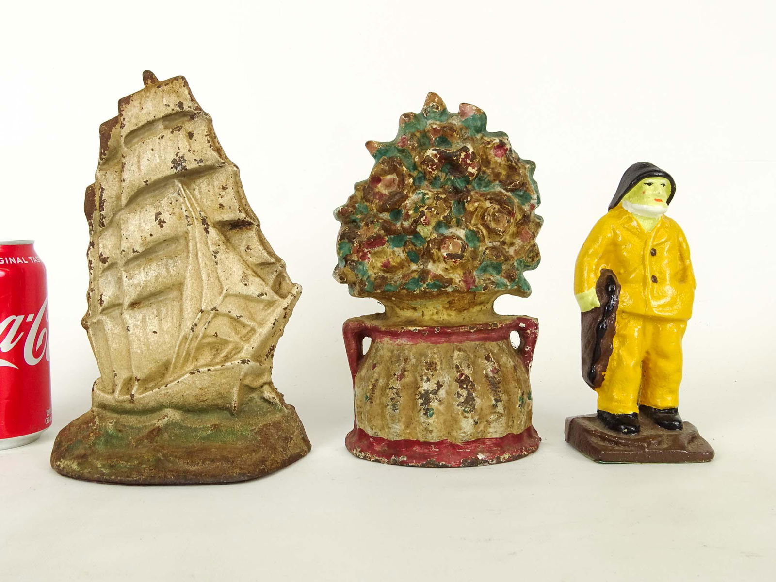 Doorstop Lot: Lot (3) cast iron doorstops including Galleon (9" Ht.), Old Salt (6 1/2" Ht.), floral (8" Ht.).
