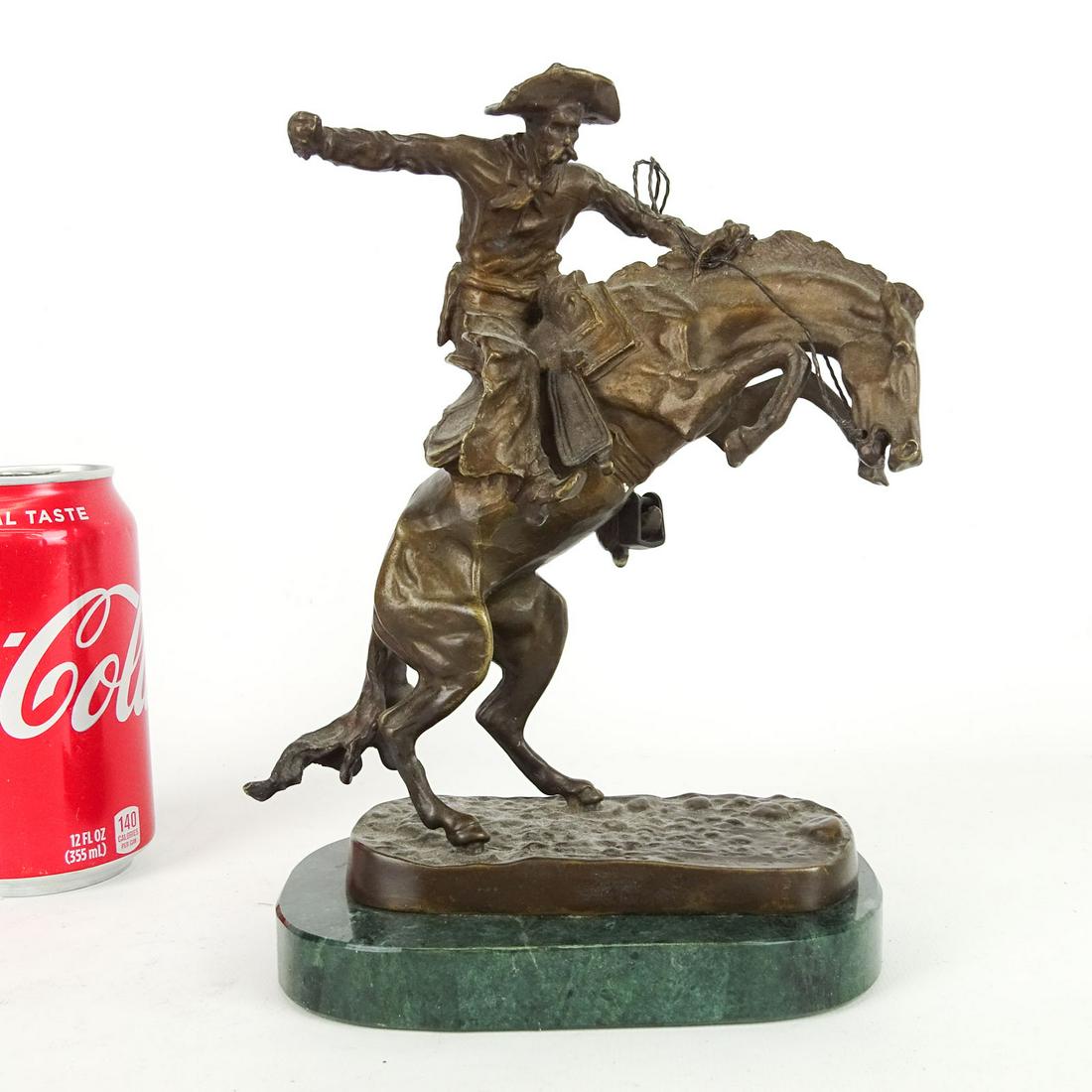 Bronze: Bronze on marble base, cowboy on horseback. 6 1/2" x 9". Marked Frederic Remington (after).