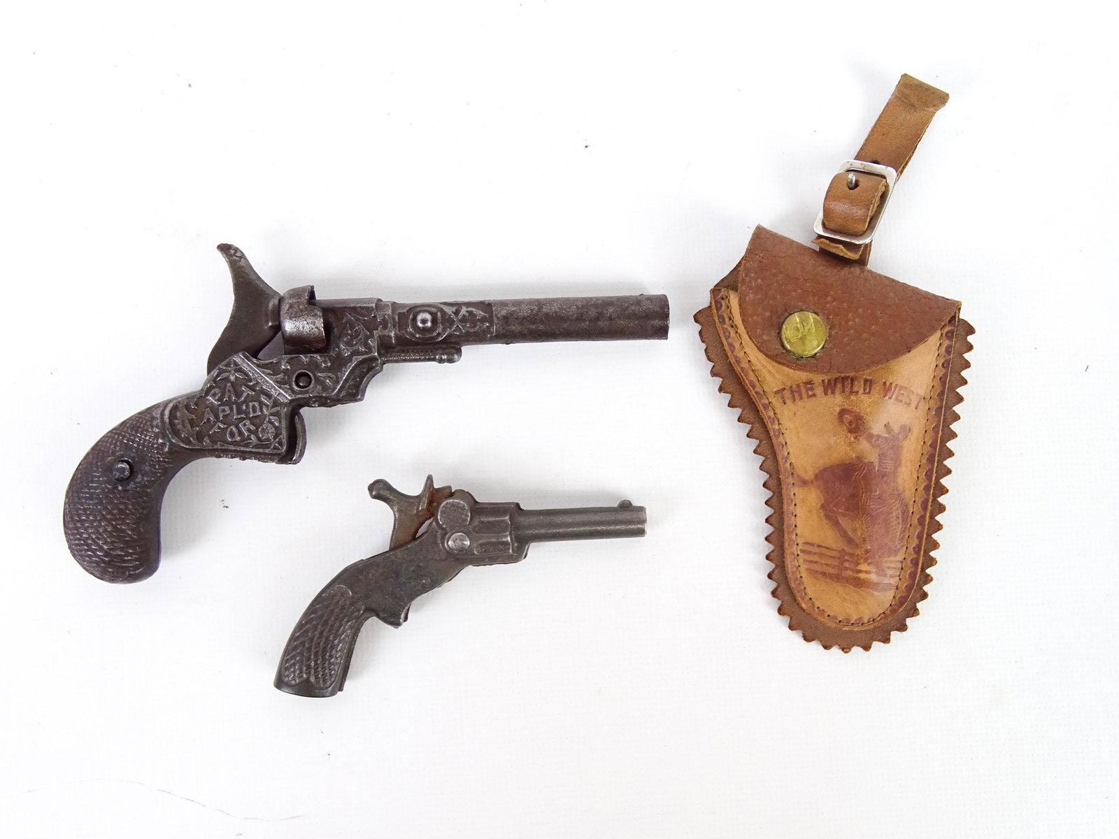 Novelty Lot: 1880's Novelty cap shooter plus a miniature cast iron Pluck gun with holster.