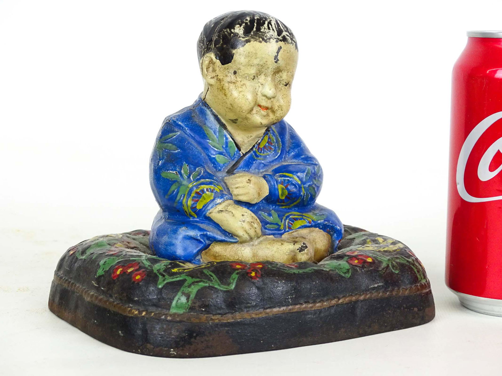 Doorstop: Hubley Takeo on Floral Cushion painted cast iron doorstop. 5 1/2" x 4 1/2" x 6".