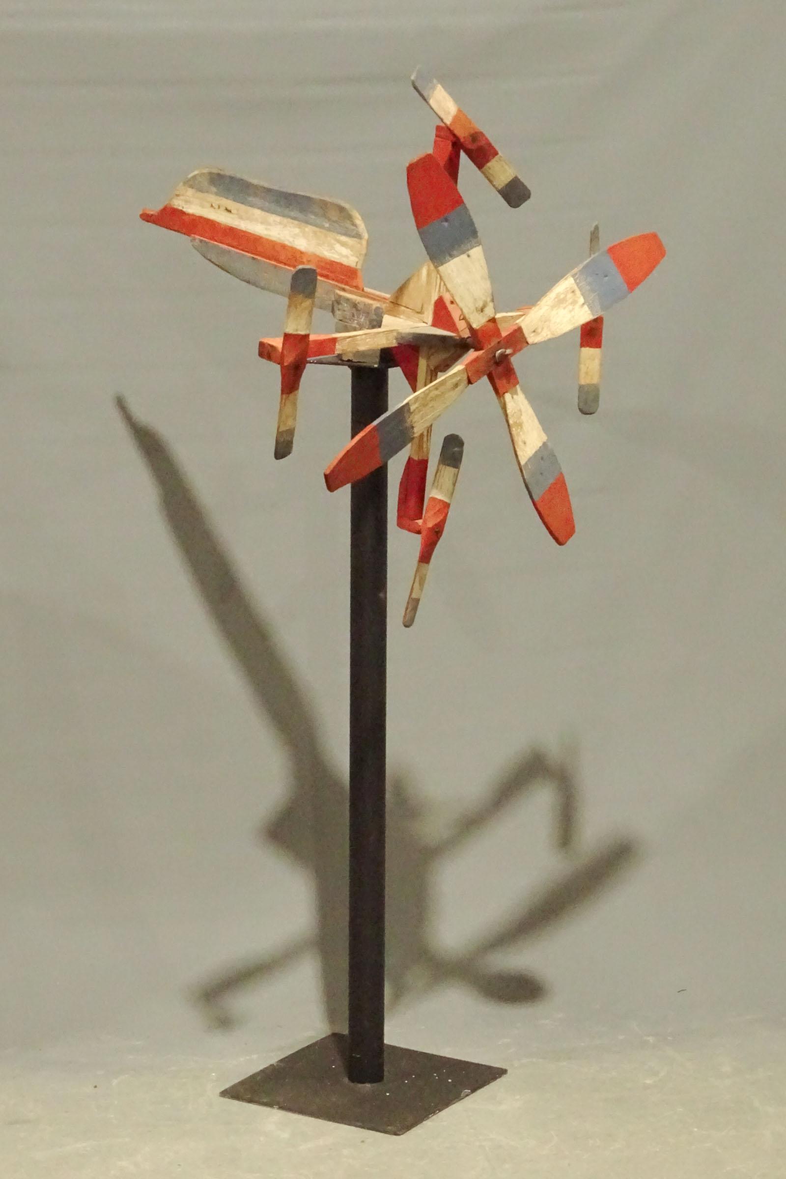 Whirligig: Early Patriotic painted wooden whirligig on custom stand. Overall on stand 38" W., 67" Ht..
