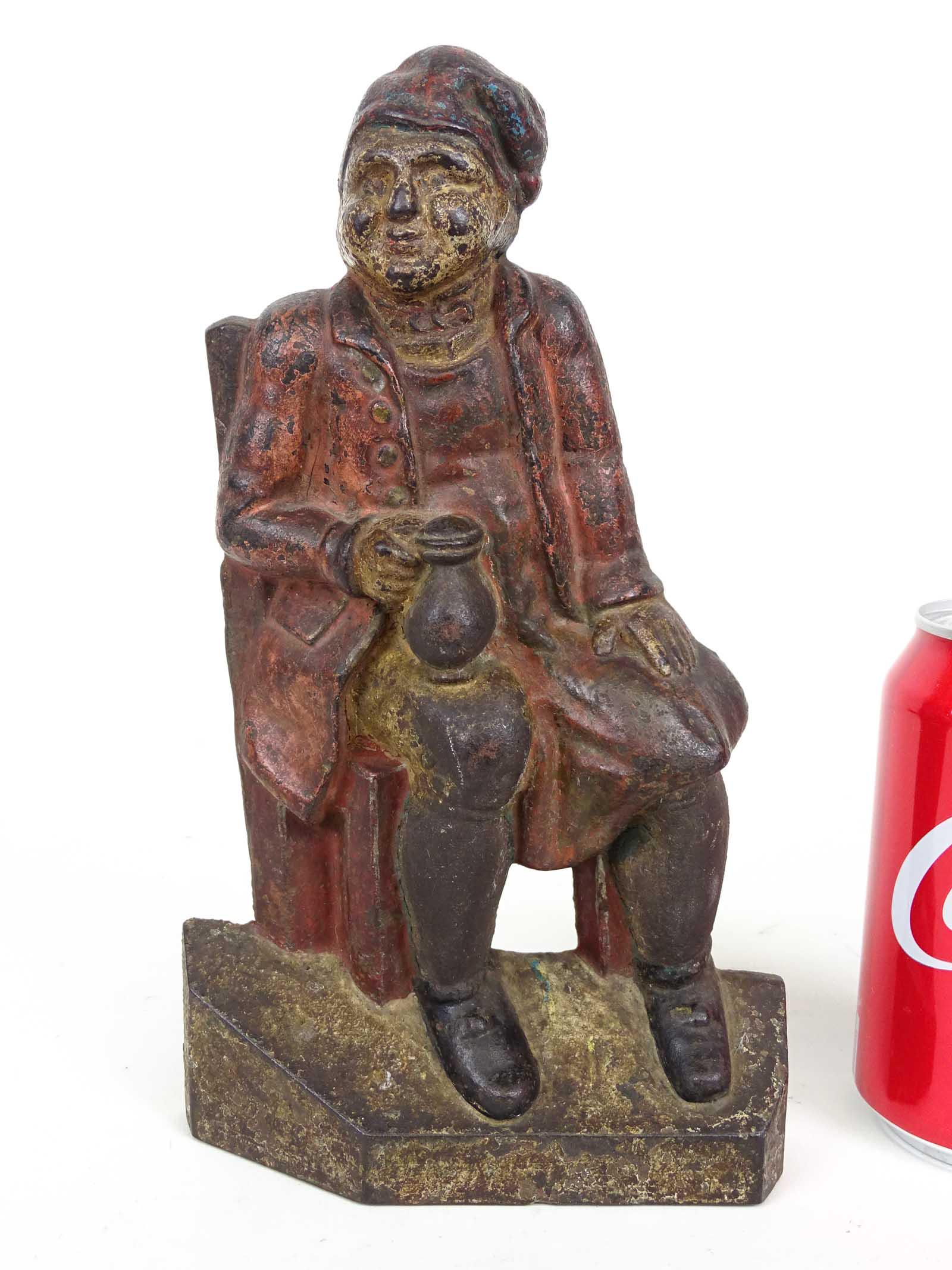 Doorstop: Cast iron Man in Chair with Ale Mug doorstop. 9 1/2" Ht..