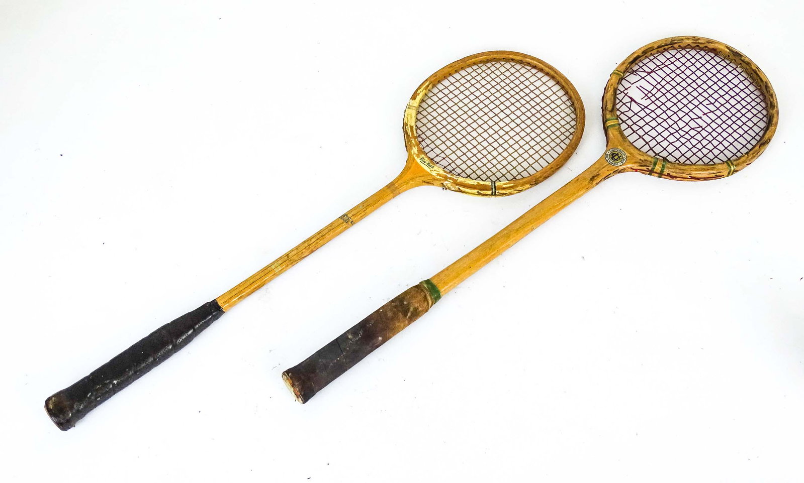 Squash Rackets: Lot (2) early Squash rackets. One marked "Apollo / UNIVERSITY CLUB / BOSTON MASS.", the other "LILLYWHITES / PICCADILLY CIRCUS". 27" L..