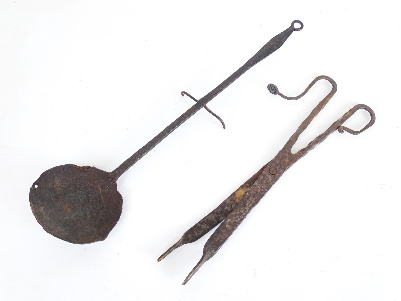 Iron Lot: Lot including 19th c. ember tongs (17" L.), and footed ladle (21" L.).