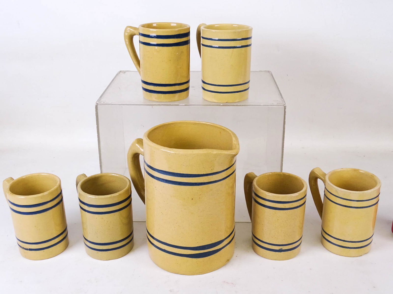 Yelloware Lot: Lot including early Buckeye yelloware pitcher with (6) mugs. Pitcher 8' Ht.. Imperfections.
