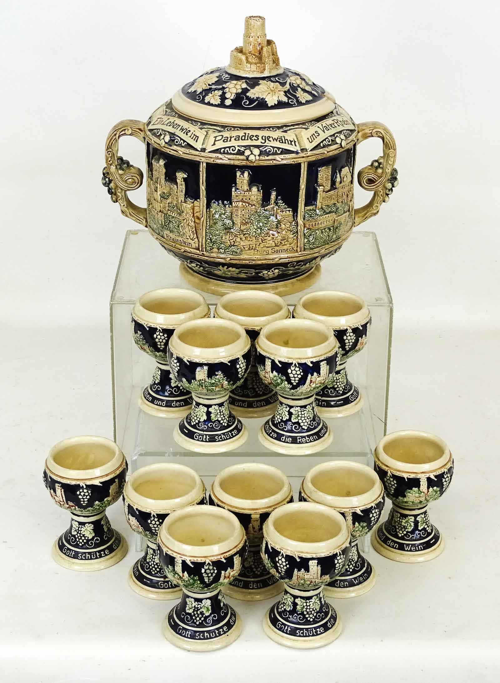 German Ceramic Punchbowl Set: German ceramic punchbowl set including tureen (approx. 12" D., 12" Ht.), along with (12) cups.