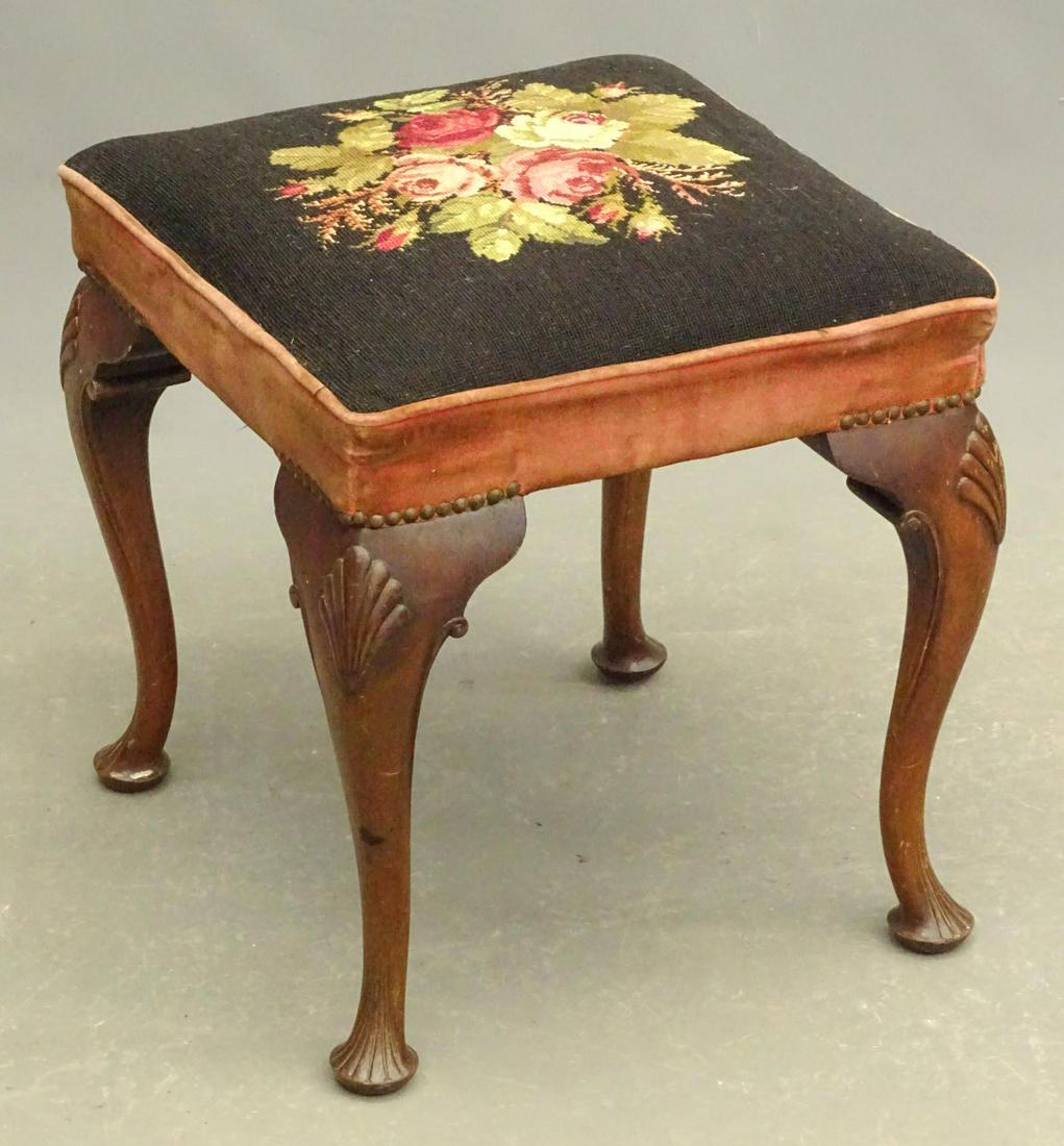 Footstool: 20th Century footstool with needlepoint seat. Carved shell knees. 19" x 18" x 19 1/2".