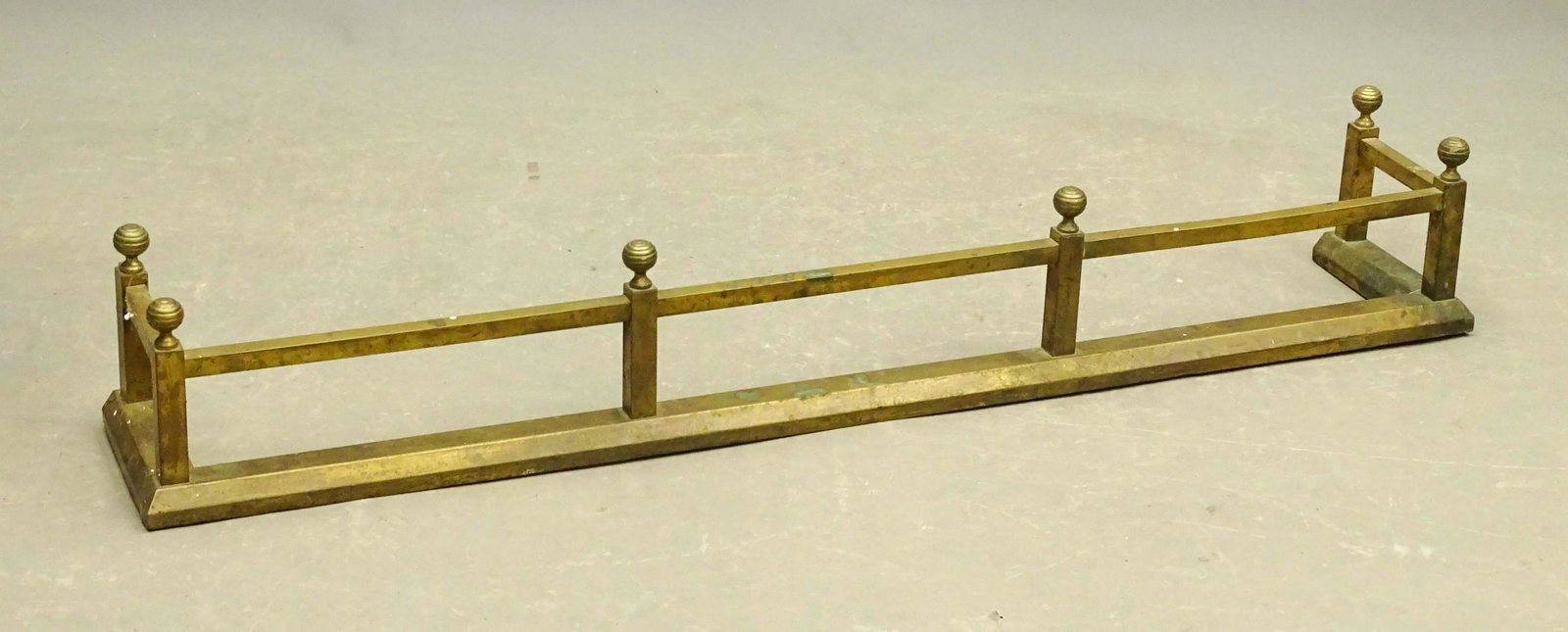 Fireplace Fender: Early fireplace fender having ribbed sphere finnials. 53" W. x 9" D. x 8 1/2" Ht..