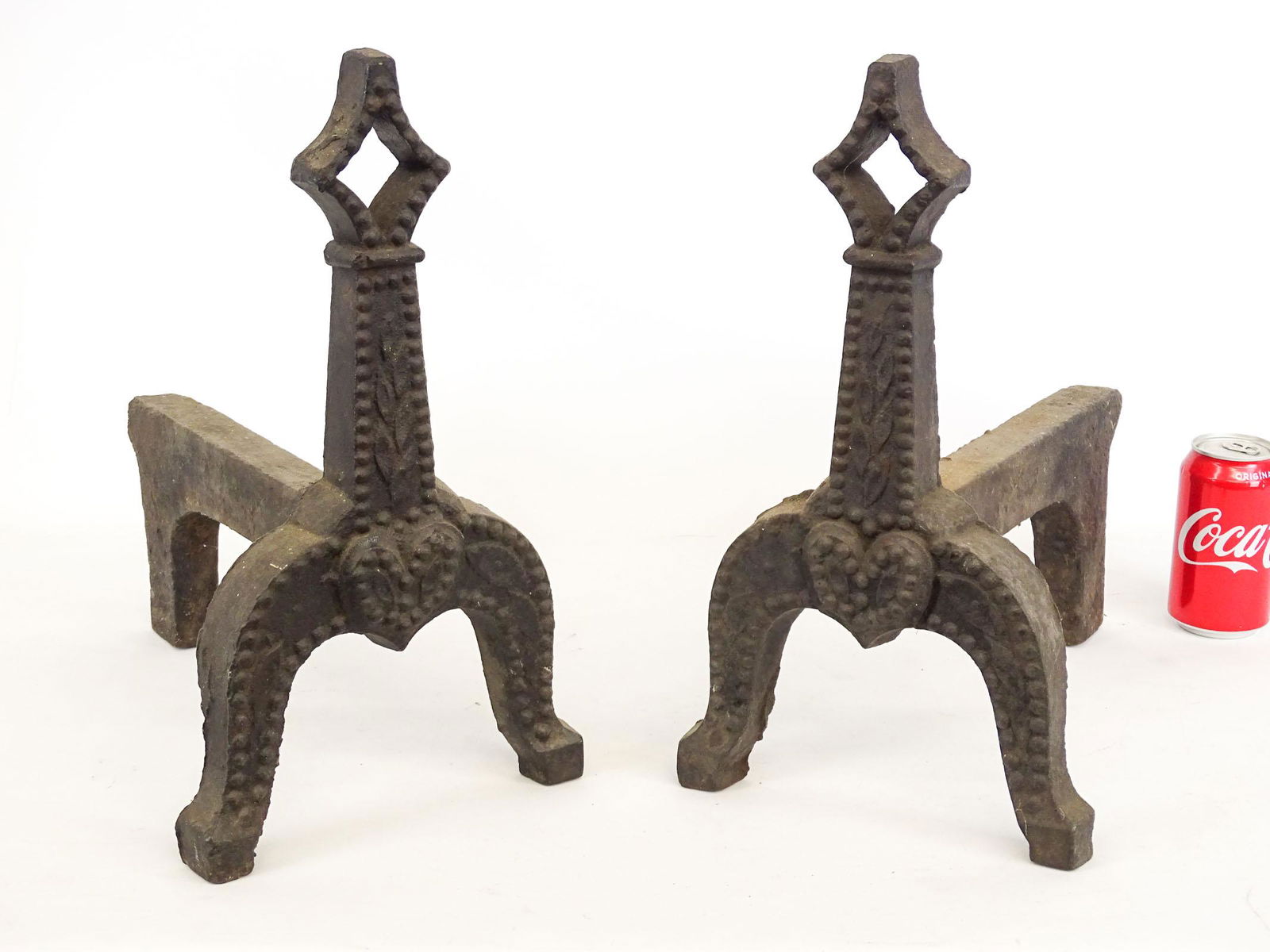Pair of Andirons: Pair of cast iron andirons with heart and leaf design. 16" Ht..