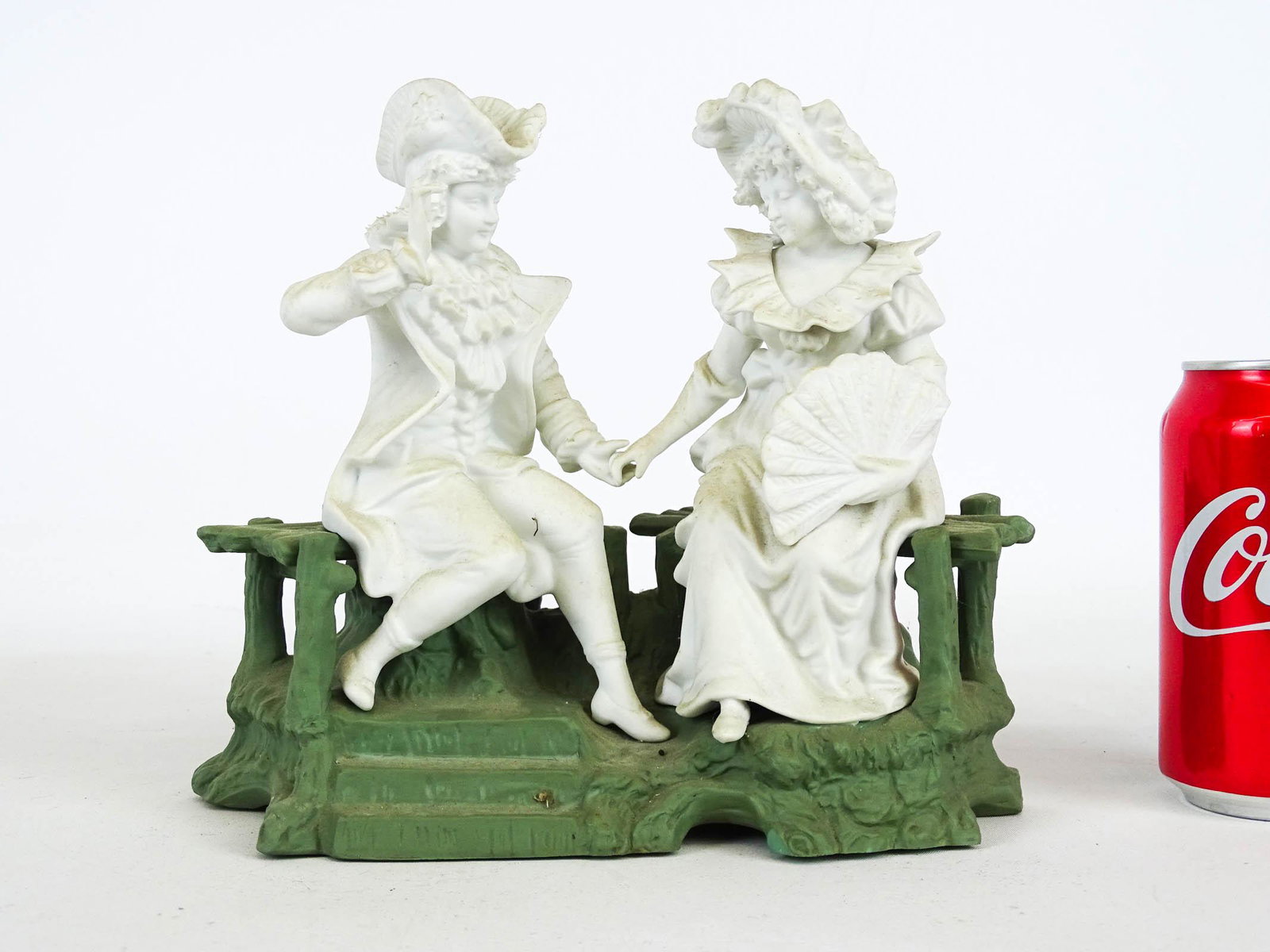 Parian Figurine Group: Parian figurine group of couple on bench. 9" W., 8 1/2" Ht..