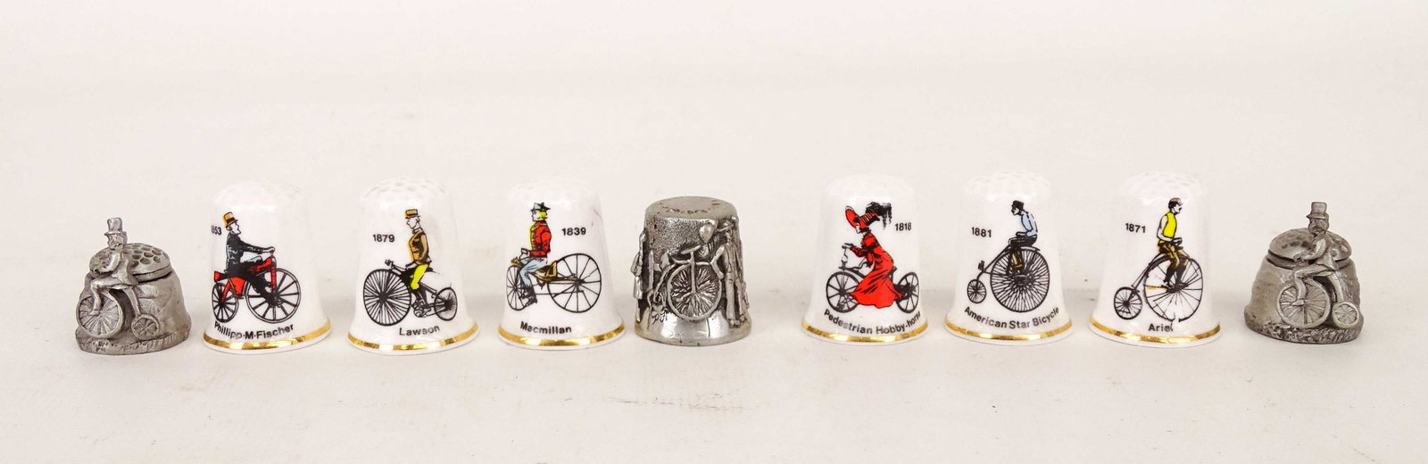 Thimble Collection: Collection of (8) bicycle motif thimbles. Good condition.