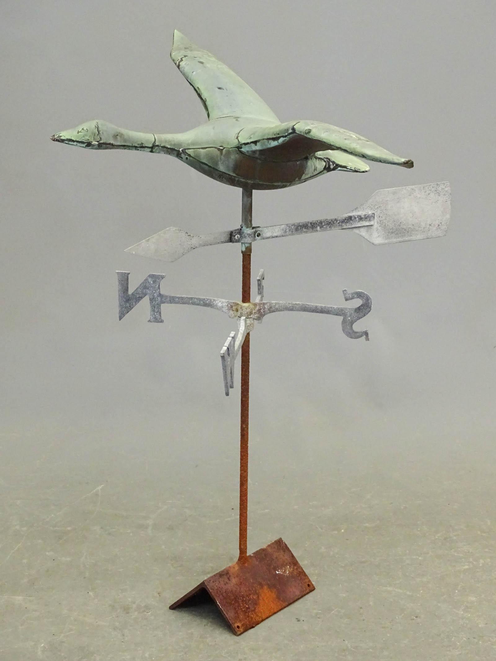 Goose Weathervane: Goose weathervane with directionals. Verdigris patina. 33" wing span, 19" D., 33 1/2" overall on stand.
