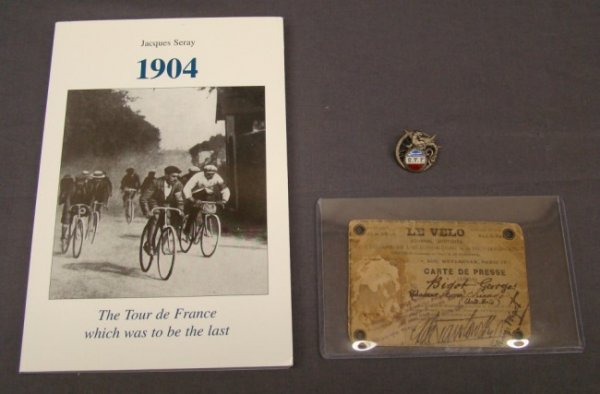 George Bilot Tour de France Items: Lot including George Bilot press pass, medal and Book "1904, The Tour de France which was to be the last" By Jacques Seray. Note pin and press pass from first Tour de France. Very rare.