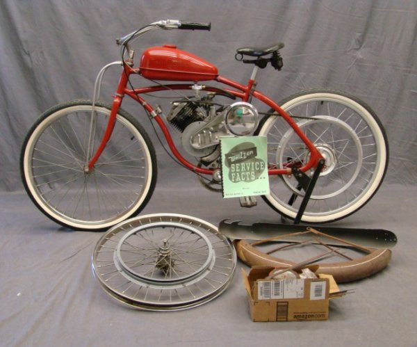 C. 1949 Whizzer: C. 1949 Whizzer, J Motor Serial #J230021, Harrington handlebars, Whizzer rear drum brake, Whizzer grip assembly. Has extra parts including wheel, fender etc. Also has service manual.