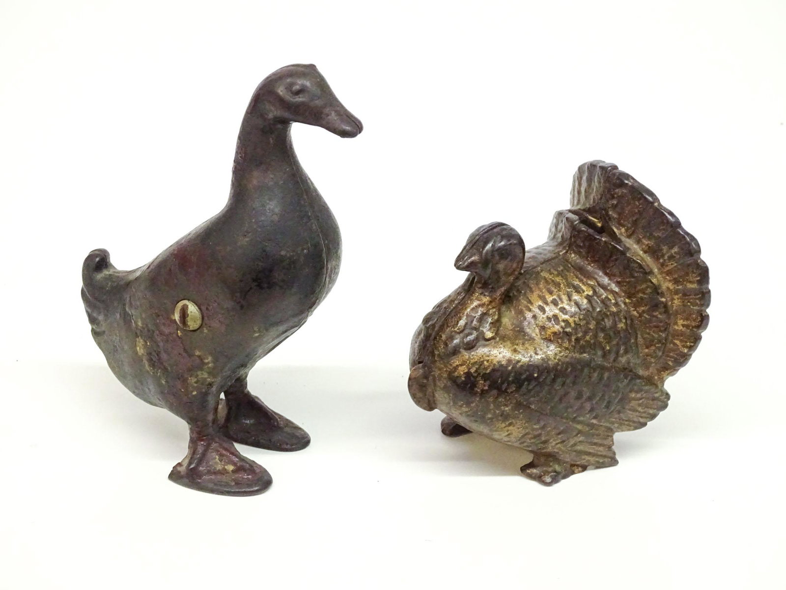 Bank Lot: Lot (2) cast iron still banks including C. 1905 A.C. Williams Turkey (3 3/4" Ht.), and C. 1909 A.C. Williams Duck (4 7/8" Ht.).