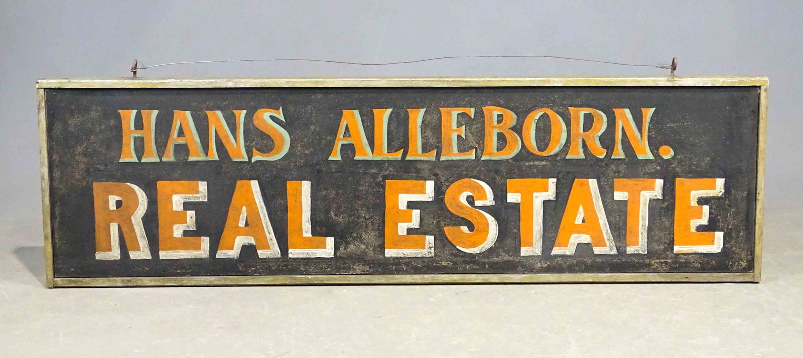 Trade Sign: Double sided trade sign "HANS ALLEBORN. / REAL ESTATE". Painted on masonite, wooden frame. 61 1/2" x 18".