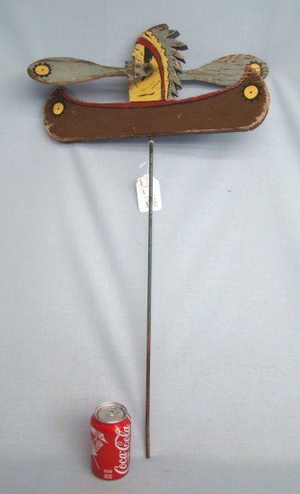 Whirligig: Indian in canoe painted wooden whirligig. 17" W 32" Ht.