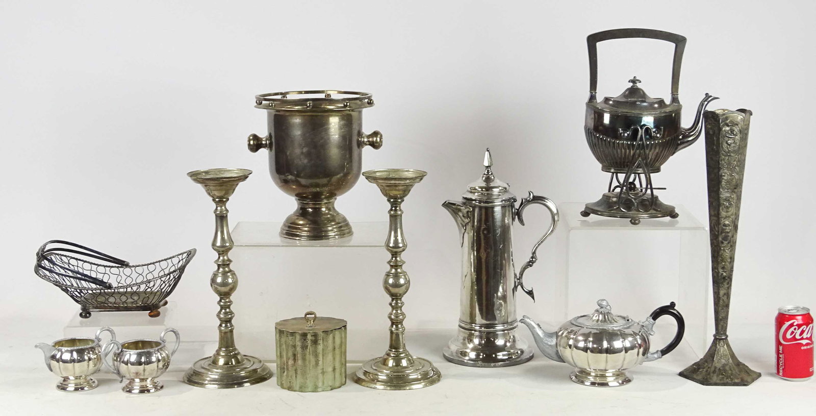 Silverplate Lot: Lot of various silverplate including tall coffee pot (16" Ht.), basket, teapot, cream, sugar, biscuit barrel, vase (18 1/2" Ht.), pair candlesticks (14 3/4" Ht.), teapot on stand and wine bucket.
