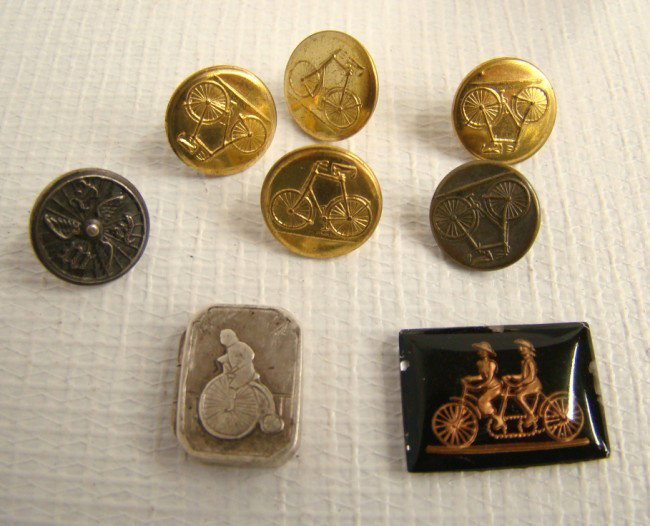 Highweel Locket And Buttons: Lot including sterling silver highwheel locket, six safety bicycle buttons and tandem pendent(?).