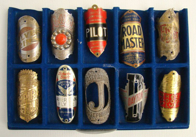 Bicycle Headbadge Collection: Bicycle Headbadge Collection: 10 pcs including: Colson Silver WIng, Rollfast, Pilot, Roadmaster, Colson Flyer, Empire, American Flyer, Josephine, Dayton, Wheel Goods Flyer. Fair-Exc cond.