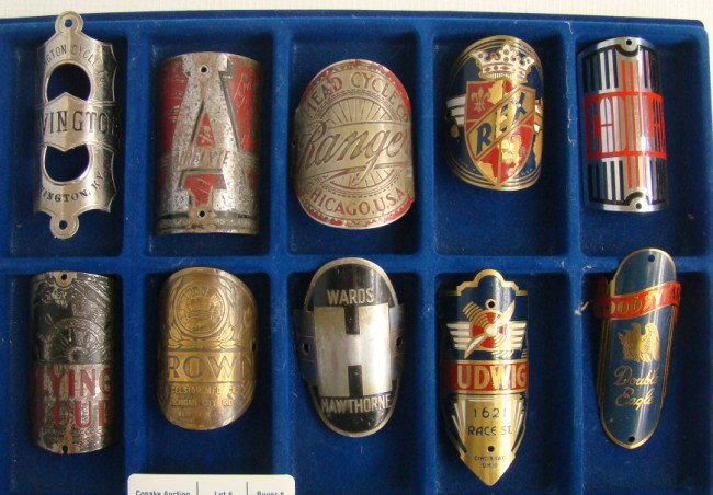 Bicycle Headbadge Collection: Bicycle Headbadge Collection: 10 pcs including: Covington, Air Flyte, Ranger, Rex, Cadillac, Flying Could, Crown, Ward's Hawthorn, Ludwig, Goodyear. Fair-exc. cond.