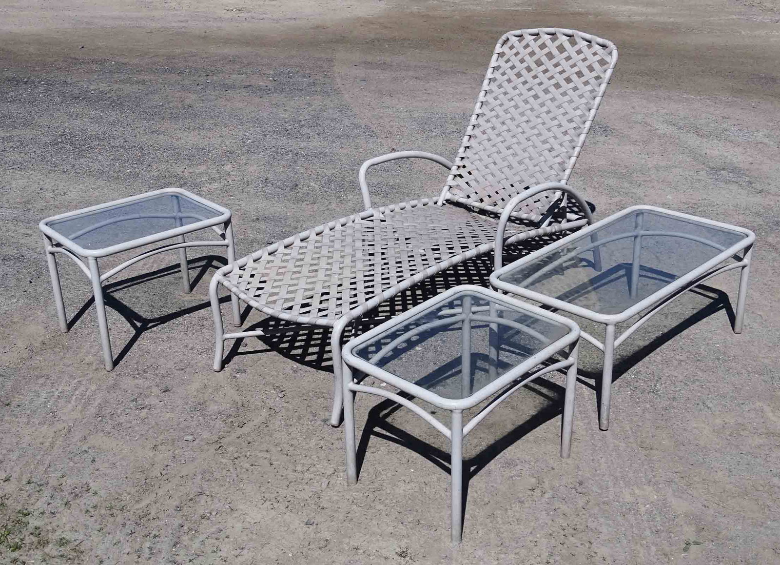 Patio Set: Patio set including: (1) chaise lounge 65" L. and (3) glass top tables Note: same manufacturer as lot 367.
