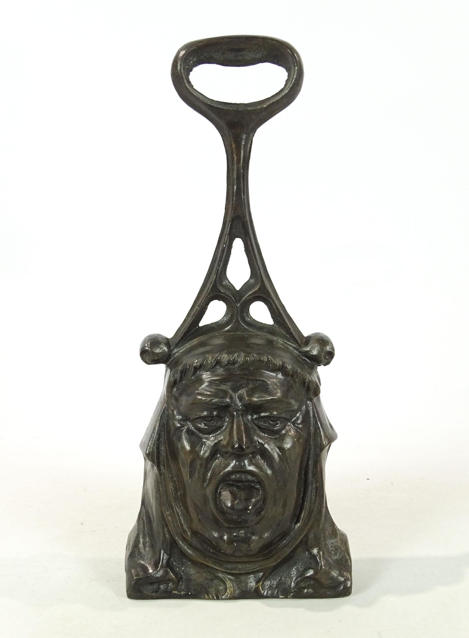 Doorstop: Cast iron face handled doorstop. 15" Ht..