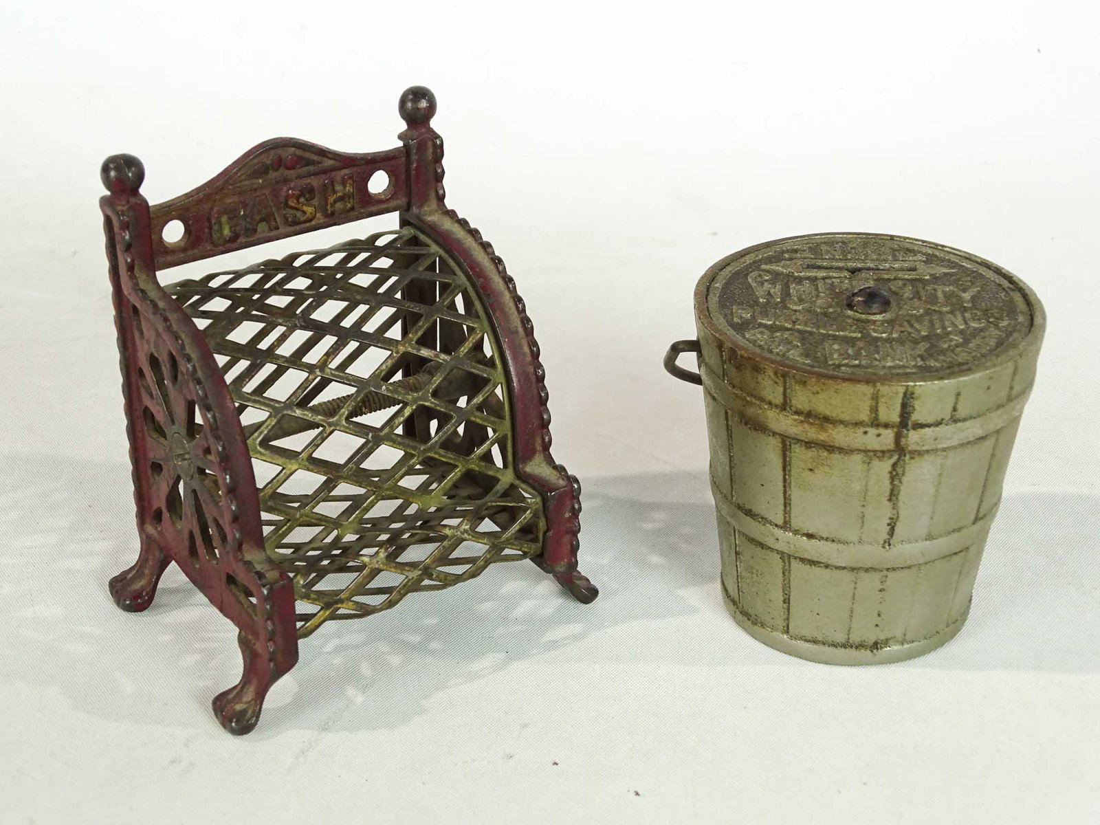 Bank Lot: Lot (2) banks including cast iron "White City Pail", (1893, 2 5/8" Ht.), cast iron "Cash Register" (with mesh, 1910, Arcade, #925 Penny Bank Book).