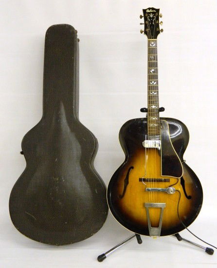 Gibson L7 Arched Top Guitar: Late 1935-1939 Gibson L7 arched top guitar with OHSC Dearmond pickup. OHSC. Serial #94710. Shrinkage to plastic pickguard, pick marks on face, minor losses to inlays on neck. Pickup has broken wire at