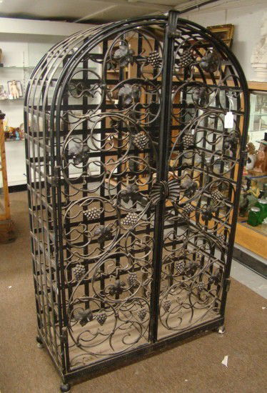 Wine Rack: Cast metal wine rack. 37" W 16" D 64" Ht.