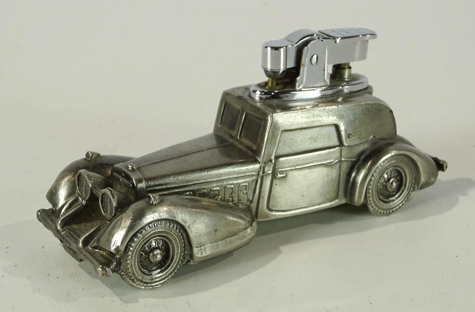 Hispano Table Lighter: Hispano Suiza table lighter in the shape of a Hispano Suiza motor car. 4 1/2" L.. Good condition.