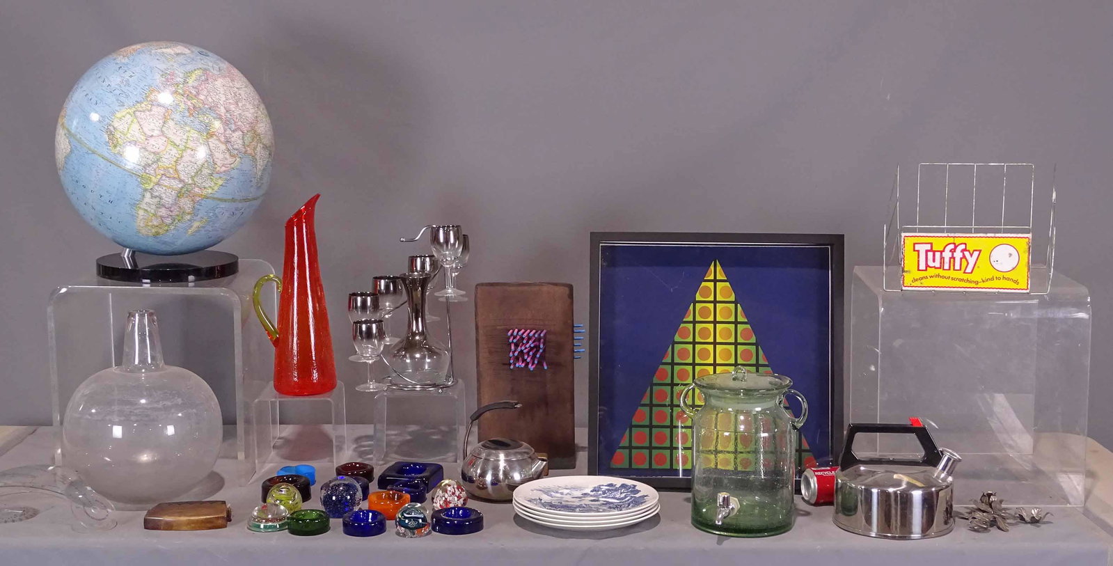Misc. Lot: Misc. lot including decorative glassware, Moderne design teapots, Modernist framed artwork, sculpture, Moderne wine set, Wedgwood plates, Globe (as found).