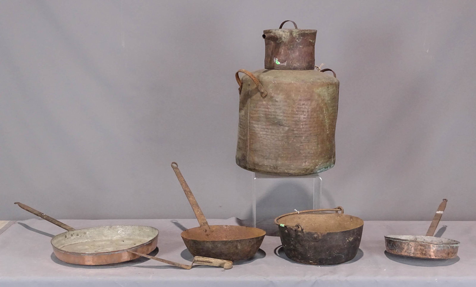 Metalware Lot: Lot including copper still (23" Ht.), swing handle pot (13" D.), pan, (2) copper poach pans (longest 30" L.).